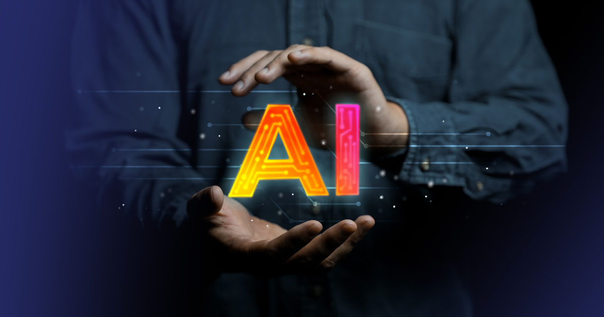 Person holding their hands around orange and red letters"AI" (artificial intelligence)