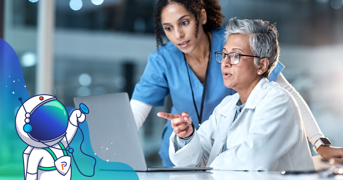 Two female physicians and healthcare professionals looking at a laptop